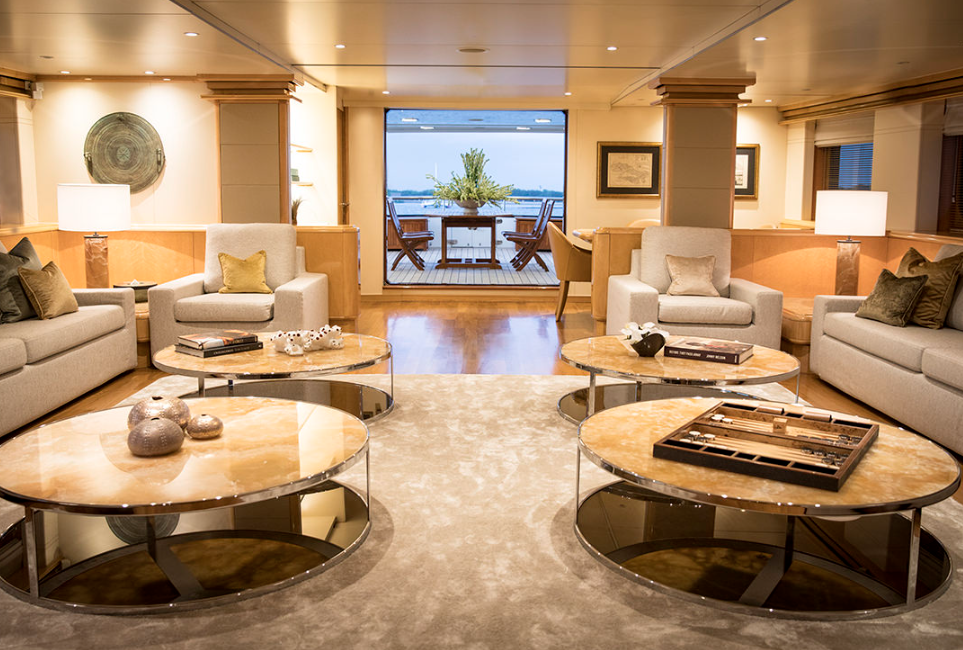 Indoor living room luxury liveaboard Indonesia with single, big sofa and round table
